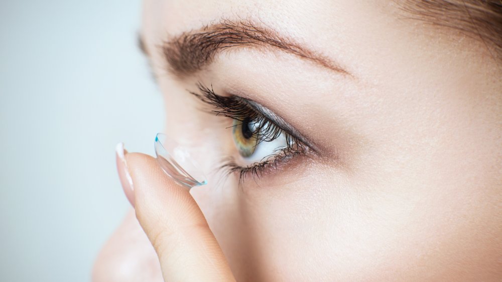 Close up of woman putting in contact lens