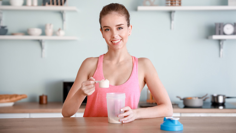 Fit woman preparing a soy protein shake