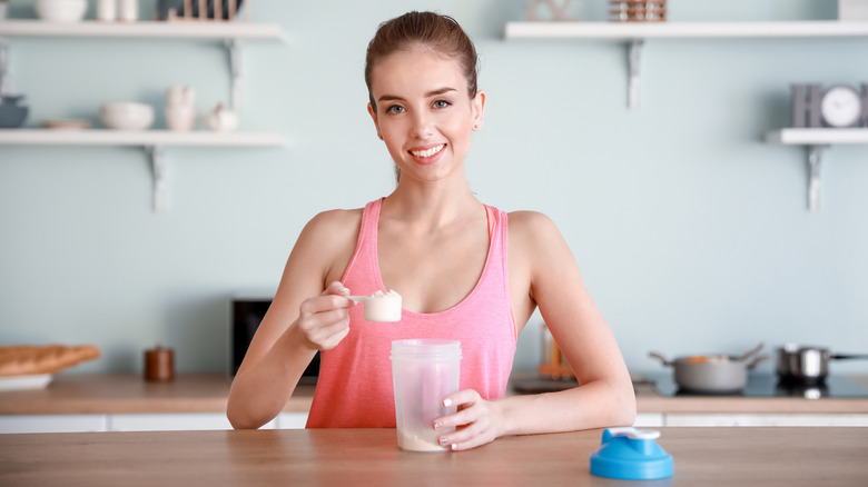 Fit woman preparing a soy protein shake