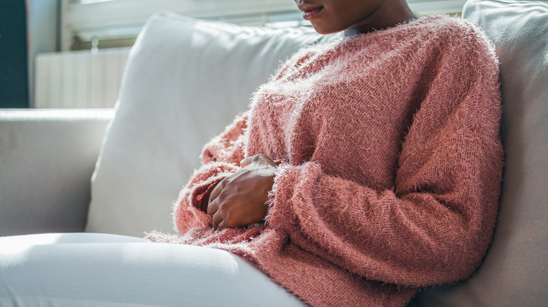 woman holding her stomach