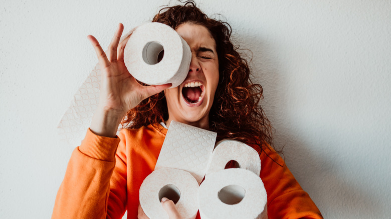 Woman holding toilet paper