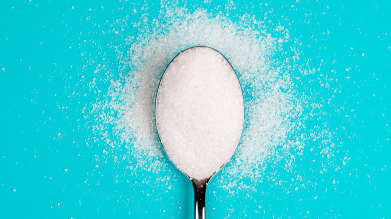 Granulated sucralose on spoon