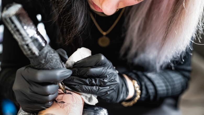 Tattoo artist giving a tattoo