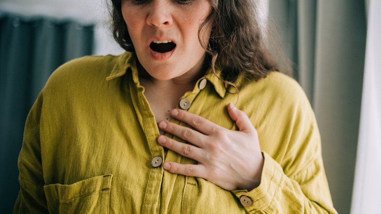 younger woman having heart pains at home