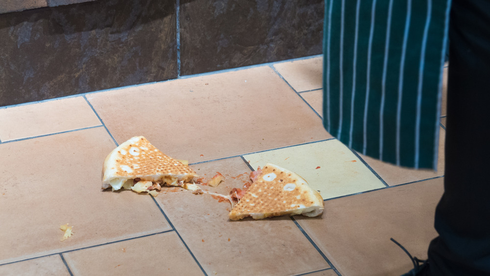 Slice of pizza dropped on floor
