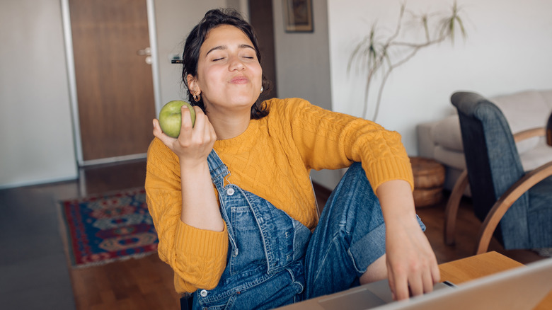 Woman eating apple