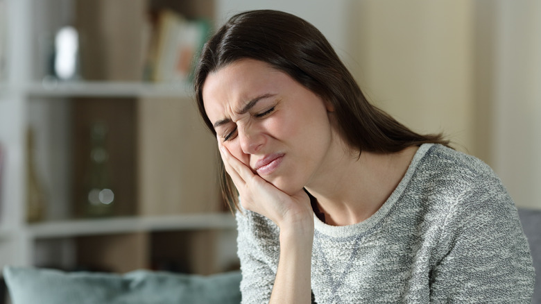 A woman experiences jaw pain