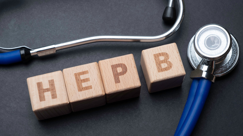 Wooden blocks form the word HEP B with stethoscope