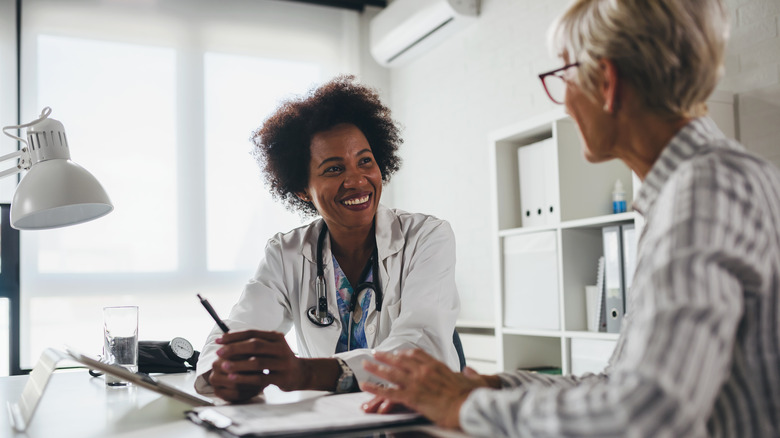 Patient speaking with smiling doctor