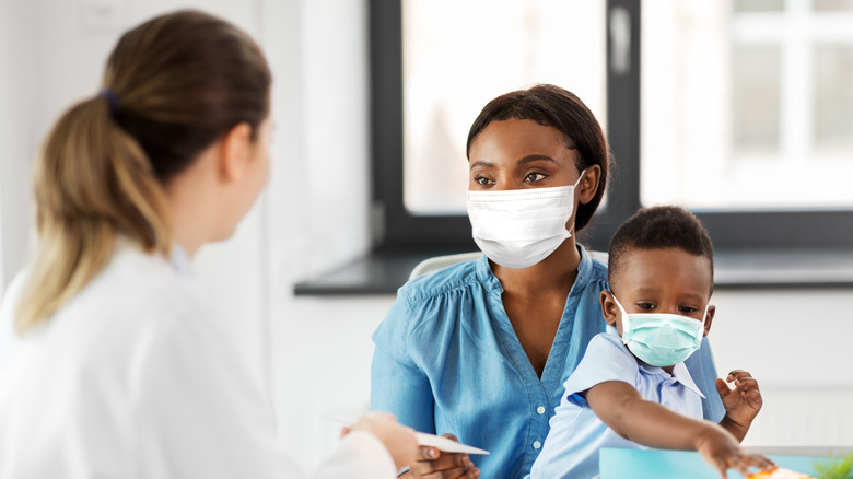 Mother and child speaking with doctor