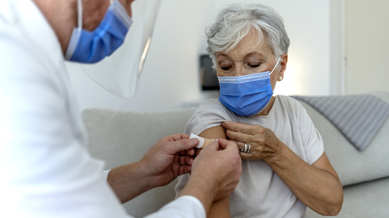 Doctor placing bandage on patient's arm