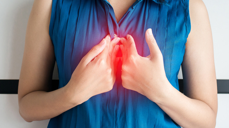 Person holding hands to chest