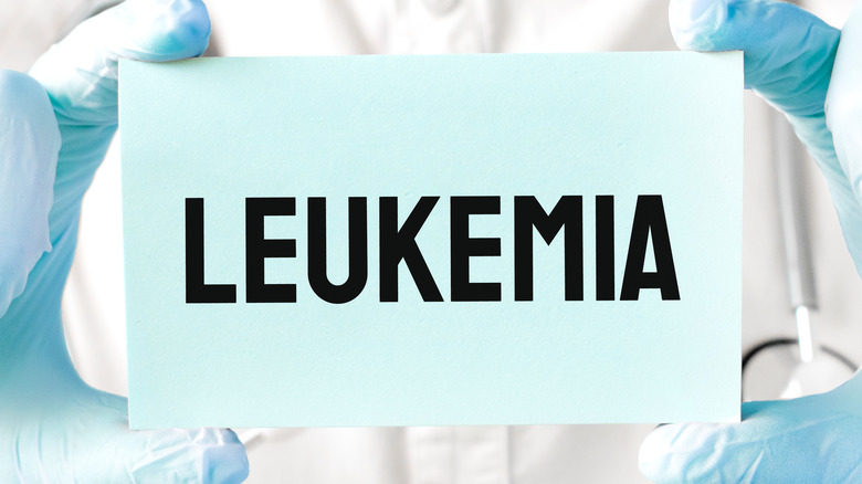doctor holding card with the word leukemia