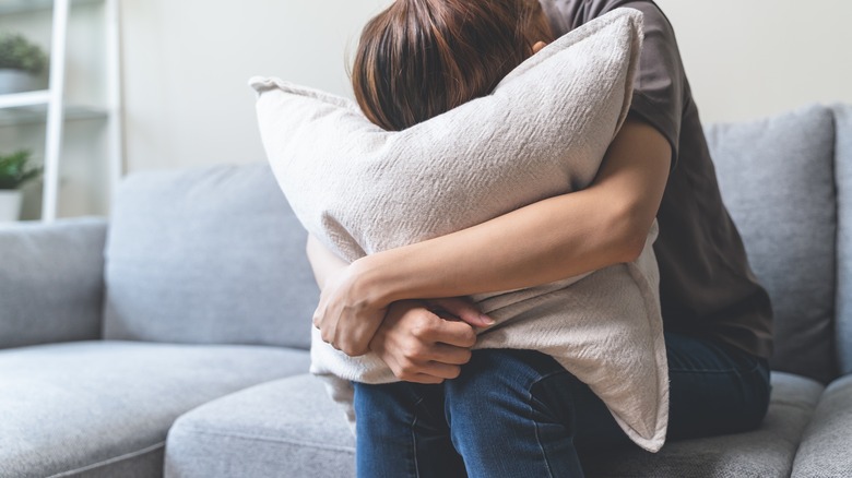 woman hugging pillow