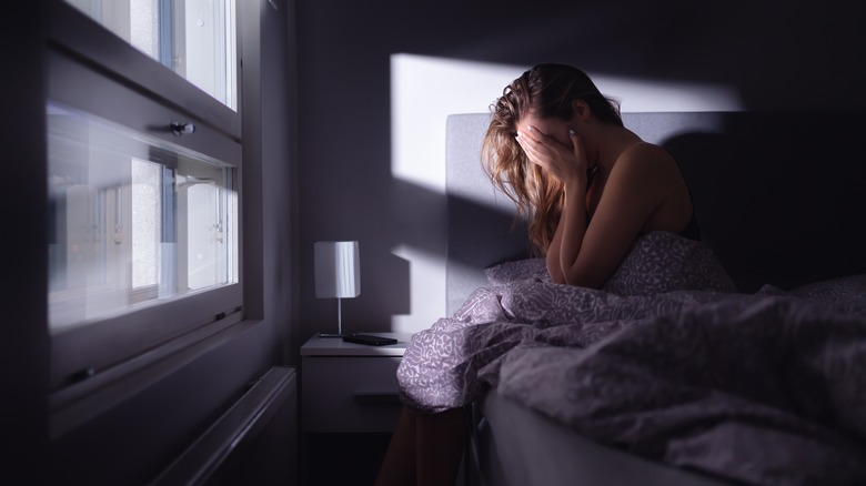 woman with anxiety in dark room