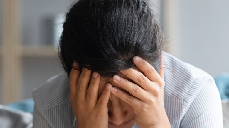 Woman on couch with headache