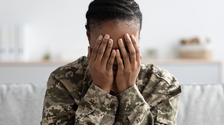 Soldier with head in hands