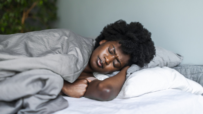 Woman in bed with fever