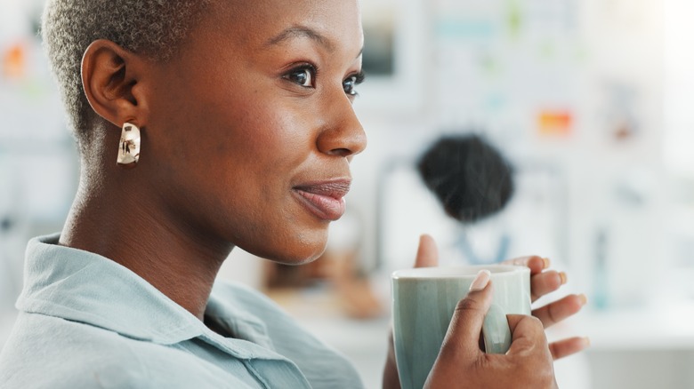 Smiling woman holding mug