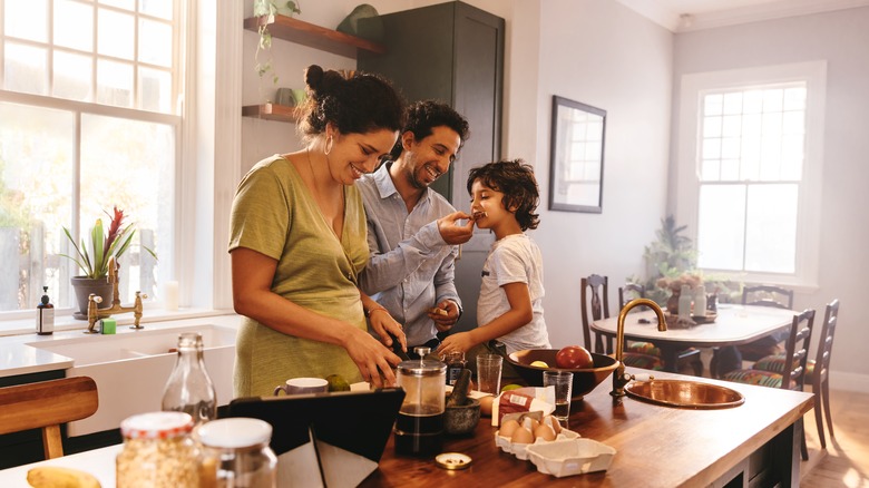 mom dad child making food