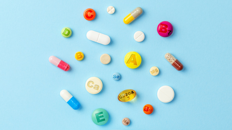 Colorful vitamin pills on a blue background