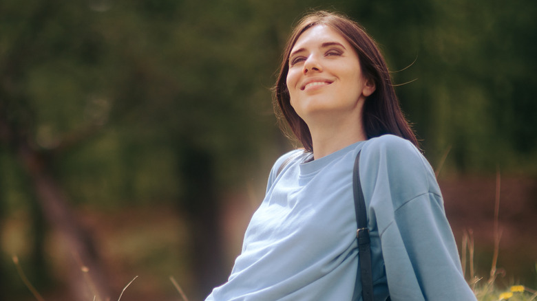 woman sitting in park soaking in sunlight