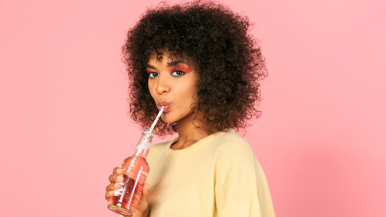 Young woman drinking vitamin water
