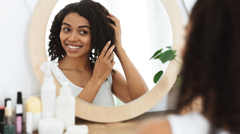 woman looking in mirror