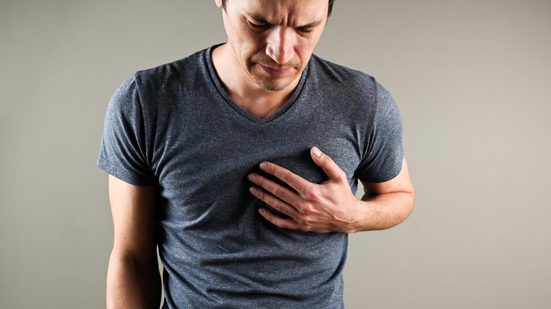 man grabbing heart