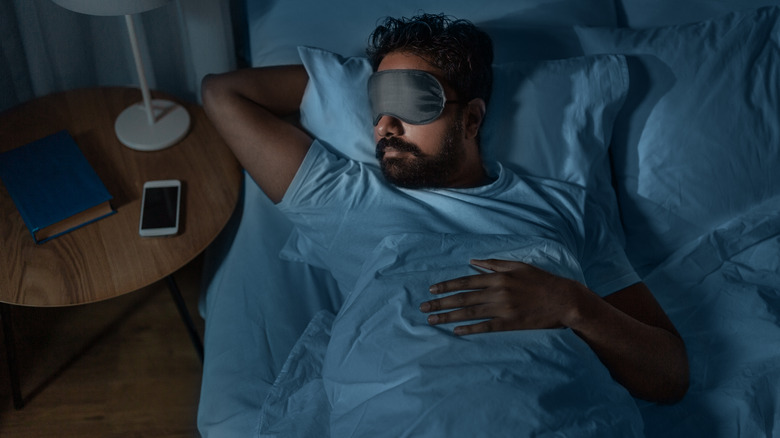 Person lying in bed on back