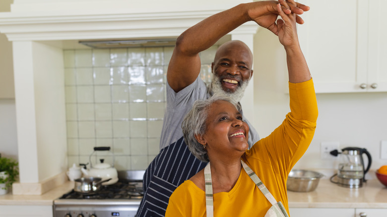 Black couple dancing in the kitchen