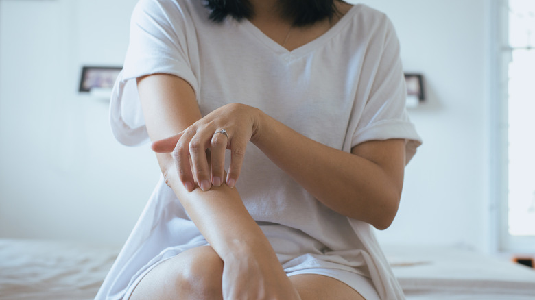 woman scratching skin