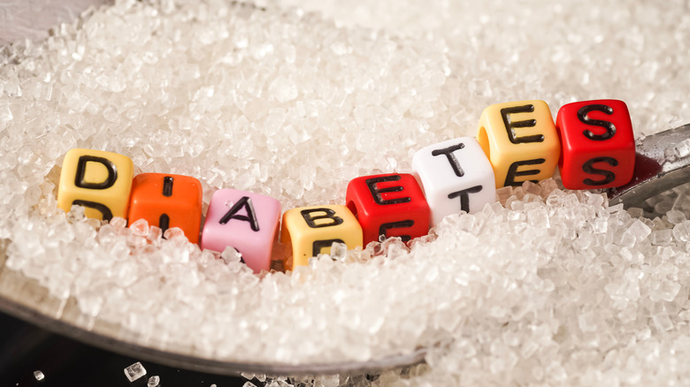 Close-up of diabetes letters on sugar in spoon