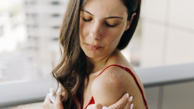 Woman looking at an itchy arm