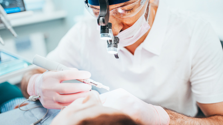 A dentist working on a patient