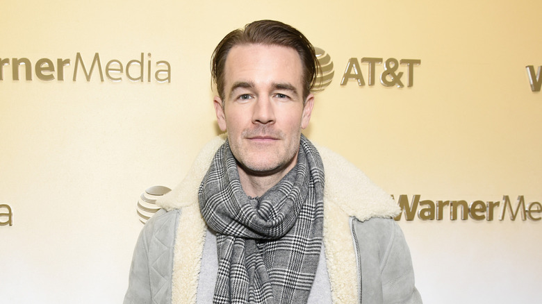 James Van Der Beek in tan coat with scarf