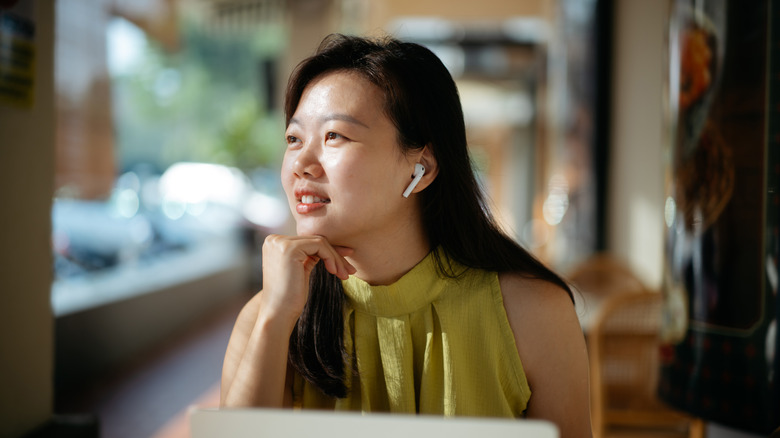 woman wearing earbuds to cancel noise