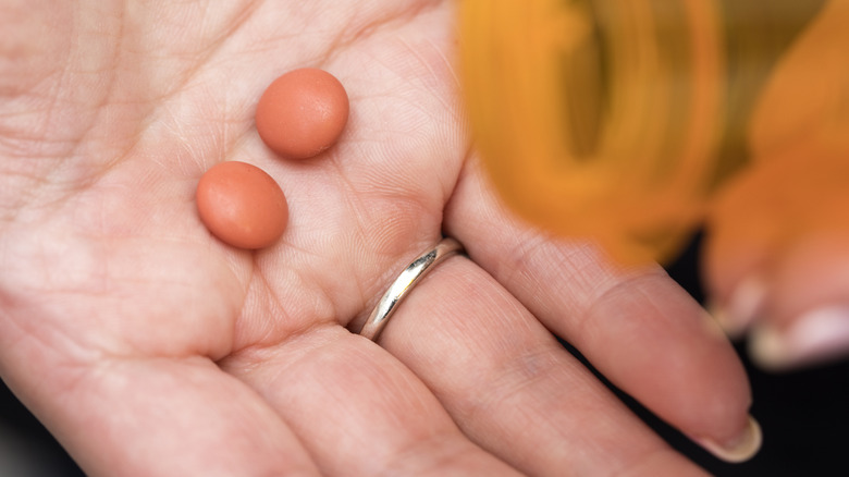 ibuprofen pills in hand of individual