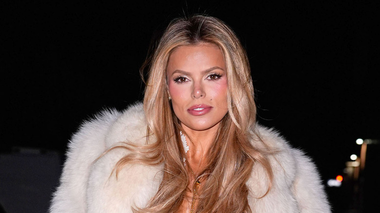 Brooks Nader posing in a white fur