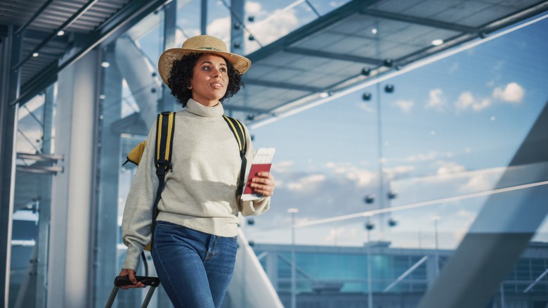 woman holding passport in airport