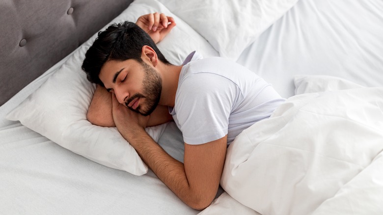 young man sleeping in bed
