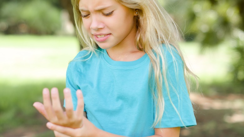 young girl with pain in hand