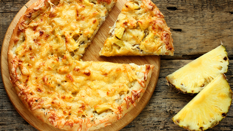 whole Hawaiian pizza with slice cut out