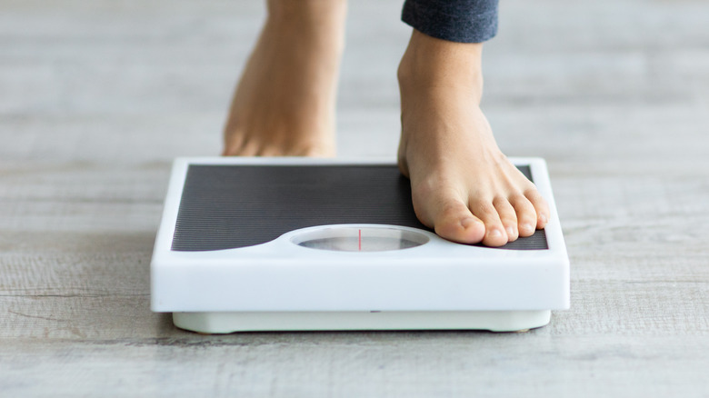 bare feet stepping on scale