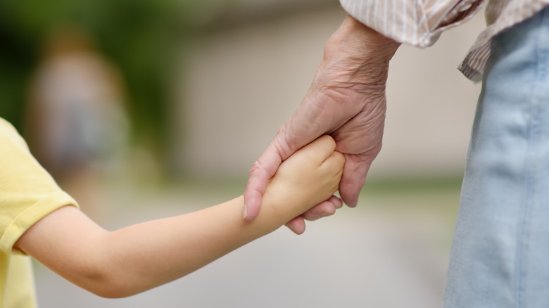 grandmother and grandchild holding hands
