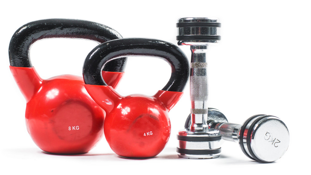 Kettlebells and dumbbells on white background