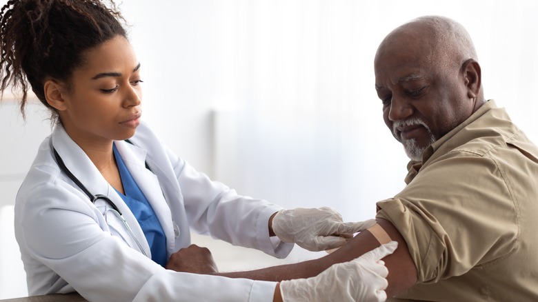 doctor giving patient covid vaccine