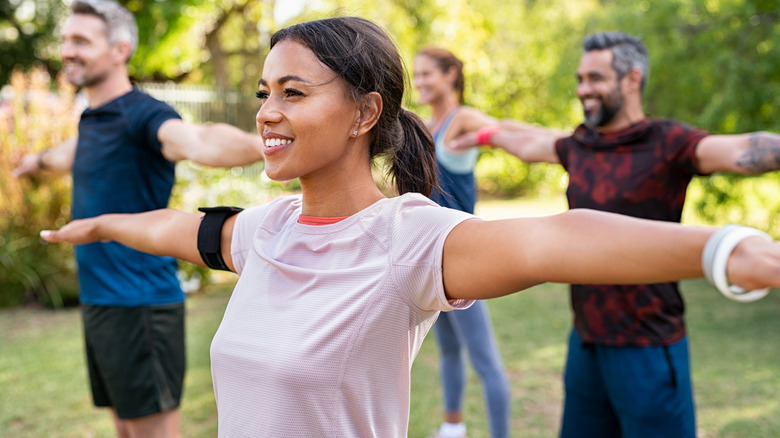 a group of people working  out 