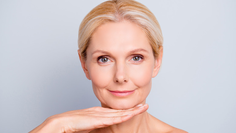 woman with hand under chin
