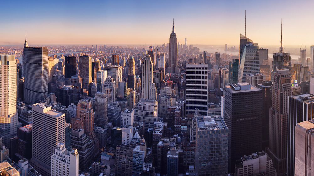 New York City skyline with tall buildings and river in background